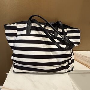 Black and White striped tote bag, zip top and outside pocket, slips over luggage
